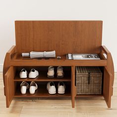 a wooden bench with baskets and shoes on it