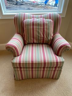 a striped chair sitting in front of a window