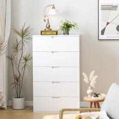 a white chest of drawers in a living room