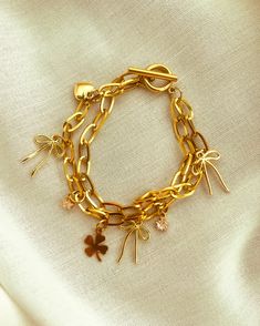 This elegant gold plated charm bracelet is an elegant way to elevate your look and add a meaningful accessory to your day to day outfits. The double chains add both character and elegance, to the bracelet. A must in any jewelry collection. Materials and perks: Chains and charms are all gold plated meaning they will not tarnish, are sweat resistant and waterproof. Size: 6 inches Handcrafted meticulously in the artistic city of Montreal. Every creation is a unique creation 1 of 1 from the designer Wrist Jewelry, Of Montreal, Double Chain, 1 Of 1, To Day, Montreal, Halloween Shopping, 6 Inches, Jewelry Collection