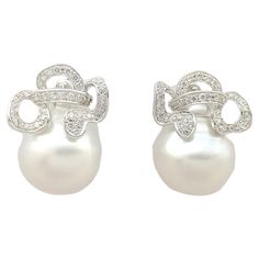 South Sea Pearl with Diamond 0.89 carat Earrings set in 18K White Gold Settings Width: 1.8 cm Length: 2.4 cm Total Weight: 18.78 grams South Sea Pearl Approximately: 15 mm "We first opened doors in 1980 when it was then situated in the vicinity of the Victory Monument; a small and modest storefront with a couple of counters. From its humble beginnings to where it stands today, our company has proven its abilities as a jeweler. Since the beginning, we have been supplying fine quality pieces to dealers, wholesalers and customers worldwide. From then till now, our business still interrelates its name with quality products and excellent service, where commitment and sincerity toward customers will always be its motto." Luxury Pave-set Pearl Earrings For Anniversary, Pearl And Diamond Earrings, Sea Pearl, South Seas, South Sea Pearls, Sea Pearls, Pearl Diamond, Earrings Set, Jewelry Earrings Studs