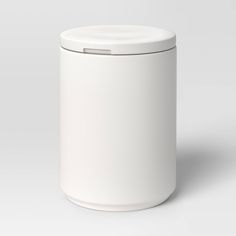 a white canister with a lid on the side