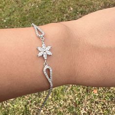 Daisy Diamond Flower Silver Charm Bracelet Anniversary Gift For Woman ⭐ All of our products are handmade and their materials are 925 sterling silver. ⭐ Bracelet lenght : 7.4'' (19 cm) ⭐ Bracelet weight : 3.69 gr ⭐ Materials: Silver ⭐ Nickel free hypoallergenic for sensitive skin. ⭐ Lightweight, perfect for everyday wear. ⭐ All of our products are handcrafted and ± 5% deviation may occur in grams and sizes. ⭐ If you have any question, contact us freely. ⭐ The light color of the photos may vary on computer and phone.      --- Care Guide --- * Unfortunately, 925 sterling and all other silver types tarnish in time. So the question is; How can we slow it down? * Contact with water: Not a great idea. But, it is unlikely to do any lasting damage. Just make sure to dry it after. * Swimming Pool: C Flower-shaped Cubic Zirconia Bracelets As Gift, Flower Shaped Crystal Bracelet Gift, Silver Sterling Silver Flower Bracelets, Silver Sterling Silver Bracelets With Flower Shape, Sterling Silver Flower Bracelets For Wedding, Silver Sterling Silver Bracelets With Flower Design, Sterling Silver Flower-shaped Bracelets, Silver Sterling Silver Flower-shaped Bracelets, Silver Flower-shaped Sterling Silver Bracelets