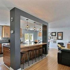 an open kitchen and living room with wood flooring