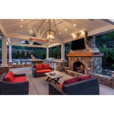 an outdoor living area with fireplace and seating