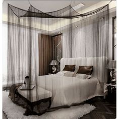 a bed sitting in a bedroom next to a window with sheer curtains on top of it