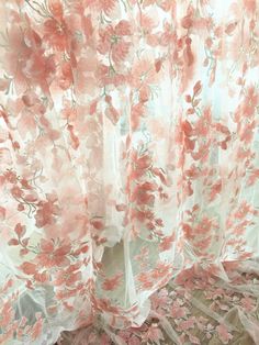 the curtains are covered with pink flowers