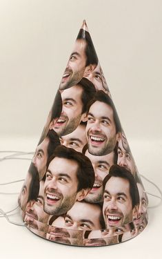 a group of men's faces on a party hat