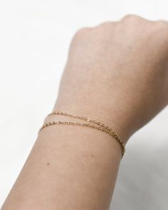 "𝗘𝗮𝘀𝘆 𝗧𝗼 𝗦𝘁𝘆𝗹𝗲, 𝗠𝗮𝗱𝗲 𝗧𝗼 𝗟𝗮𝘀𝘁 Our double wrapped chain is a classic and minimalist addition to your everyday bracelet stack! 𝗠𝗮𝘁𝗲𝗿𝗶𝗮𝗹𝘀 𝗪𝗲 𝗨𝘀𝗲 This bracelet is made entirely with sturdy 14k gold filled or sterling silver pieces. It is safe to wear in the shower, but we recommend avoiding prolonged exposure to chemicals like chlorine to keep your bracelet like new! 𝗟𝗲𝗻𝗴𝘁𝗵 𝗢𝗽𝘁𝗶𝗼𝗻𝘀    This bracelet is available in 5\", 6\", 7\", and 8\" sizes. Each comes with a 1\" extender chain. 𝗠𝗼𝗿𝗲 𝗗𝗲𝘁𝗮𝗶𝗹𝘀 -Chain measures 1.3mm -Spring ring clasp 𝗘𝘅𝘁𝗿𝗮𝘀 𝗮𝗻𝗱 𝗔𝗱𝗱 𝗢𝗻𝘀 Gift Box This gift box has a velour interior and features a sliding drawer style; it is a perfect place to keep your piece when it's not being worn! https://www.etsy.com/li Minimalist 14k Gold Charm Bracelet With Delicate Chain, Minimalist Gold Charm Bracelet For Friendship, Everyday Double Chain Rose Gold Jewelry, Dainty Yellow Gold Chain Bracelet For Layering, Minimalist Hypoallergenic 14k Gold-filled Bracelets, Minimalist Hypoallergenic 14k Gold Filled Bracelets, Tarnish Resistant Chain Bracelet For Layering, Gold Tarnish-resistant Bracelets For Layering, Minimalist Yellow Gold Jubilee Charm Bracelet