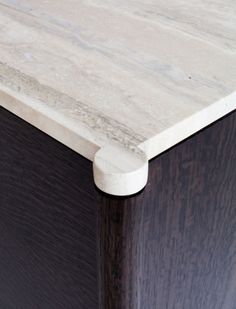 a close up view of the top of a wooden cabinet with white paint on it