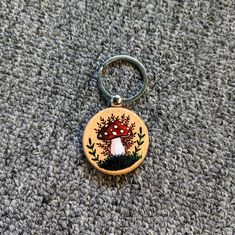 a keychain with a mushroom painted on it