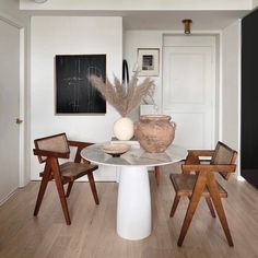 a white table with some chairs around it