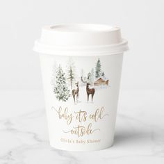 a cup with the words baby it's cold outside and two deers on it