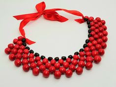 Beautiful wooden necklace. A wonderful accessory for the bride or bridesmaids or girls. Made of high quality materials, The perfect accessory and gift for any woman Handmade Color: red Red Wooden Beads Round Necklace, Red Necklace With Wooden Beads, Red Wooden Bead Necklace As Gift, Red Wooden Beaded Necklaces For Gifts, Red Wooden Beads Jewelry For Gift, Red Wooden Beads Jewelry As A Gift, Red Wooden Beaded Necklaces As Gifts, Red Wooden Beads Jewelry Gift, Elegant Party Necklace With Wooden Beads