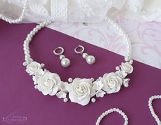 "White roses necklace Bridal jewelry set Wedding bib necklace Bridal flower necklace set White floral bridal necklace Pearl bridal jewelry White  floral statement necklace and earrings for the bride. This bridal jewelry set will wonderfully decorate a wedding dress and complete the look. This set with flowers and pearls looks very gentle on the bride. Flower rose, made of polymer clay. For these flowers I used high quality polymer clay Fimo. Each flower is made by hand in a special technique. Ci Elegant Flower Shaped Wedding Jewelry Sets, Elegant Flower-shaped Wedding Jewelry Sets, White Flower Bridal Necklace For Wedding, White Floral Bridal Necklace For Wedding, Elegant White Flower Jewelry Sets, White Wedding Jewelry With Flower Decoration, White Flower Decoration Wedding Jewelry, Formal White Rose Design Jewelry, Formal White Jewelry With Rose Design