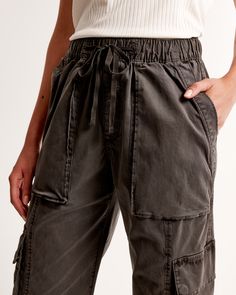 Elevate your casual wardrobe with the Abercrombie & Fitch Women's Pull-On Wide Leg Cargo Pant in a sophisticated dark grey. These pants blend functionality with style, perfect for the modern woman on the go.

- Size: M SHORT
- Color: Dark Grey
- Material: Body and pocket bag made from cotton
- Gender: Female
- Age Group: Adult
- Features: High-rise, wide-leg silhouette, elasticated waistband with functional drawcords, cargo-inspired details, zipper detail at cuffs, multiple pockets

Crafted from Utility Pants With Elastic Waistband And Relaxed Fit, Utility Wide-leg Cotton Bottoms, Utility Style Wide-leg Cotton Bottoms, Cotton Wide-leg Utility Bottoms, Utility Cargo Pants With Relaxed Fit And Pull-on Style, Relaxed Fit Paperbag Waist Bottoms With Pockets, Spring Utility Bottoms For Elevated Casual, Casual Cargo Pants With Paperbag Waist, Relaxed Fit Utility Pants With Pull-on Style