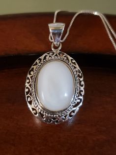 "Beautiful natural MOTHER-OF-PEARL necklace. The 18x14mm oval white Mother of Pearl is surrounded by an intricate, layered bezel setting. It almost looks like a cake from the side🤭 The large bale is hinged, and will certainly accommodate other chains too. Pendant measures 1.5\" long including the bale, and 22mm across. All Sterling Silver, weighs 9.3 grams 18\" Sterling Silver box chain Hallmarked 925 THAILAND (with maker's mark) Brand New Contact me with any questions" Classic White Oval Pendant Jewelry, White Sterling Silver Oval Cabochon Jewelry, Ornate Oval Cabochon Necklaces, White Oval Gemstone Jewelry, White Oval Necklace For Anniversary, White Oval Necklaces For Anniversary, Spiritual Oval Cabochon Necklace, Ornate Oval Pearl Pendant Jewelry, White Oval Pearl Pendant Jewelry