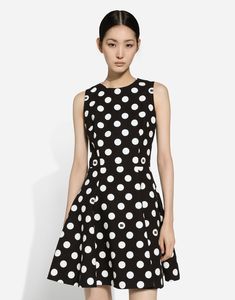 Short cotton rush-stitch brocade dress with polka-dot print: Black and White Sleeveless Partially lined in stretch silk Rear zipper and hook-and-eye fastening The piece measures 48 cm from the waist down on a size IT 40 The model is 175 cm tall and wears a size IT 40 Made in Italy The difference in the print placement that you may find on this product is a feature of Dolce & Gabbana’s “Handmade” pieces. A detail that makes every garment or accessory unique and exclusive. Chic A-line Polka Dot Dress, Polka Dot Sleeveless Evening Dress, Chic Fitted Polka Dot Dress, Polka Dot Evening Dress For Spring, Elegant Mini Dress With Polka Dot Pattern, Summer Polka Dot Dresses With Fitted Bodice, Spring Cocktail Dress In Polka Dot, Spring Cocktail Dress With Polka Dots, Polka Dot Cocktail Dress For Spring