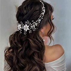 a woman wearing a bridal hair comb with flowers on the back of her head