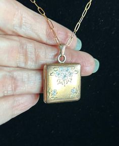 This sweet gold-filled square-shaped locket features an engraved two-tone floral design on the front and handsome stripes on the back. On the inside, there are two intact photo frames and shields which protect a handsome soldier and a lovely lass.  The 16" delicate 14k  yellow gold-filled chain matches the locket's elegance and style. Antique Locket, Floral Squares, Locket Necklace, Gold Filled Chain, Photo Frames, Locket, Favorite Jewelry, Gold Filled, Necklace Lengths