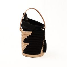 The Coba Basket Bag is the perfect carry-all for your personal items or toting a favorite bottle of rose' to the beach. The tote has a natural leather handle, a black cotton drawstring lining to secure your belongings and is finished off with a black leather tassel. It's natural style all the way from city to beach. Made from raffia, nylon and cow leather Measures: 7"H 6"W (not including handle) Black Bucket Bag With Handles For Travel, Black Leather Bucket Bag With Leather Handles, Modern Black Shoulder Bag For Beach, Black Travel Bucket Bag With Handles, Black Tote Bucket Bag For Travel, Black Bucket Bag Tote For Travel, Everyday Black Bucket Bag With Leather Handles, Black Beach Bag With Handles For Travel, Black Bucket Tote Bag For Travel