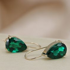 Beautifully matched, these dangling earrings feature Deep Green pear shaped Emeralds set in 14k gold of your choice. Three-prong settings hanging from an elegant french hook. Each stone weighs roughly 2.5 carats, for a total weight of 5.00 carat minimum. - Made to Order, perfectly finished, Fast shipping fully insured and trackable online. - Gemstone information: Two 12x8mm pear cut, Chatham Emeralds 10.04 ctw - Solid Gold French hook for quick and easy removal. - Arrives gift ready with a certi Elegant Green Teardrop Earrings For Anniversary, Classic Green Earrings For Party, Green Teardrop Earrings For Formal Occasions, Green Drop Teardrop Earrings For Formal, Elegant May Birthstone Teardrop Earrings, May Birthstone Drop Earrings For Formal Occasions, Formal Drop Earrings For May Birthstone, Green Pear-shaped Earrings For Formal Events, Formal Green Teardrop Drop Earrings