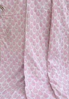 pink and white patterned fabric with small flowers on the top right corner, as seen from above