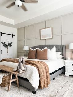 a bedroom with a large bed and white walls