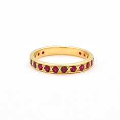 Gold Ruby Ring set with Created Ruby in a flawless diamond cut & stunning red color, at size 2mm each (2 Cts combined).Gold Vermeil: 18k Gold over Solid 925 Sterling Silver ☞ made to last.Matching Pendant - please ask meMatching Earrings- please ask me Details:• Created Ruby in a flawless clarity• Ruby: 2mm each, 1 Ct combined, diamond cut• Dimensions: Band width ≈ 3mm, thickness ≈ 2mm• Solid 925 Sterling SilverSKU 2430 Luxury Ruby Eternity Band As A Gift, Elegant Red Ruby Eternity Band, Elegant Red Round Eternity Band, Ruby Eternity Band With Prong Setting For Formal Occasions, Formal Ruby Eternity Band With Prong Setting, Luxury Stackable Ruby Jewelry, Elegant Red Round Cut Eternity Band, Red Ruby Eternity Band In Fine Jewelry Style, Red Diamond Rings With Channel Set