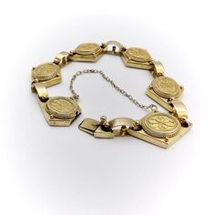 This is part of Chairish’s Fine Jewelry assortment.  A beautiful 14k yellow gold bracelet from the Etruscan Revival period, circa 1880. The bracelet is exquisitely hand-made and is a fine example of cannetille gold work, which is similar to filigree work with fine gold wires that curl around thinly hammered sheets. Cannetille gold work was inspired by embroidery and nature. The repeating curling designs on each segment of the bracelet are harmonious and elegant. The diamond shape of the segment Antique 14k Gold Bangle Bracelet, Antique 14k Gold Bracelet Engraved, Antique Engraved 14k Gold Bracelet, Vintage Yellow Gold Engraved Bracelet, Victorian Gold Bracelets For Wedding, Victorian Style Gold Bracelets For Wedding, Vintage Engraved Yellow Gold Bracelet, Antique Gold Antique Bracelet, Antique Gold Bracelet In Antique Style