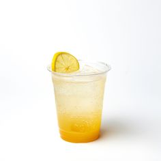 a glass filled with liquid and a slice of lemon