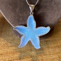 Pretty Remarkable Vintage Acrylic Starfish Charm Surrounded In A .5” Sterling Shaped Band. The Light Blue Colors Radiate Into A Multi Colored Light Catching Sparkler. The Sterling Chain Is 16” Long And Marked As Made In Italy And Stamped As Sterling (925). The Pendant And Bale Measure 3” In Length. With A Thickness Overall Of .5” Blue Starfish Charm Necklace, Blue Star-shaped Nickel-free Necklace, Silver Starfish Charm For Jewelry Making, Silver Jewelry With Starfish Charm For Jewelry Making, Silver Starfish Charm Jewelry, Ocean-inspired Silver Necklace With Star Charm, Blue Sterling Silver Necklace With Starfish Charm, Blue Sterling Silver Necklaces With Starfish Charm, Ocean-inspired Silver Star Jewelry