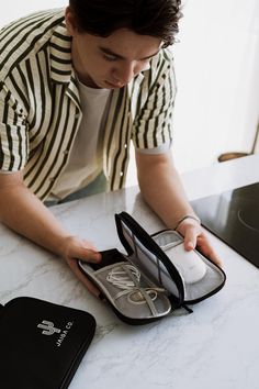 a man sitting at a table with an open case