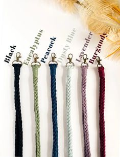 six different colored ropes are hanging on a white sheet with the words braided into them