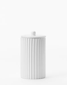 a white canister with a lid on it