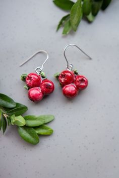 Add a touch of autumn to your style with our Handmade Cranberry Drop Hook Earrings 🍂, crafted with love in our small Liiber Design art studio. These cranberry fruit-inspired earrings make a perfect gift for fruit lovers and vegans alike, offering a minimalist red berry charm that's both elegant and playful. Choose from dangle hook, French hook, or stud options to match your personal style. Each pair is meticulously made from polymer clay, hand-painted, and finished with a waterproof varnish for Handmade Berry Colored Earrings For Gift, Cherry Colored Earrings For Valentine's Day Gift, Handmade Berry Earrings For Gift, Cherry Earrings For Valentine's Day Gift, Cherry Color Earrings For Valentine's Day Gift, Nickel-free Cherry Colored Earrings For Gift, Nickel Free Cherry Colored Earrings For Gift, Nickel Free Cherry Earrings For Gift, Berry Colored Fruit Design Earrings For Gift