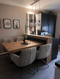 a dining room table with four chairs around it