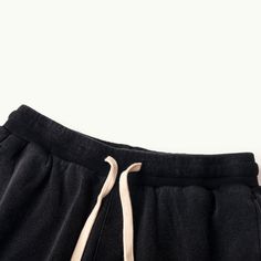 Baggy Cotton Black Cargo Shorts Beach - Raw Edge Helms - The baggy black cargo shorts are instantly eye-catching in the urban setting. Carefully crafted from 320GSM high-quality combed cotton with a breathable French Terry interior, these comfy shorts are tailored to a laid-back fit with design details that make them stand out from other cargo shorts. The side accordion pockets provide functionality and a structured look, while the distressed hem adds a rugged and edgy touch that contrasts perfe Washed Black Sweatpants With Pockets For Streetwear, Washed Black Bottoms With Elastic Waistband For Streetwear, Washed Black Cotton Sweatpants For Streetwear, Casual Washed Black Sweatpants With Pockets, Casual Sweatpants With Pockets In Washed Black, Cotton Cargo Shorts With Drawstring, Black Cotton Pants For Leisure, Black Relaxed Cotton Bottoms, Black Relaxed Fit Cotton Bottoms