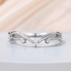 a white gold wedding band with three diamonds