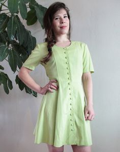 Apple Green Button Down Summer Dress with a Bow Fresh as a breath of summer air. It comes in a vibrant light green color, that a has a tint of yellow in it. Closes with a long line of buttons, made with the same fabric, and it can be fitted in the back with a large bow. It has shoulderpads, but those can be removed (they are attached with a separate seam). So it has evrything to look as cute as a button, and be comfortable at the same time. The fabric is soft to the touch, has a twill weave, and Dress With A Bow, Light Green Color, Cute As A Button, Twill Weave, Large Bow, Green Button, Apple Green, Dress Clothes For Women, Costume Design