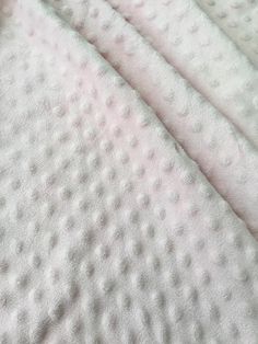 the blanket is white with dots on it