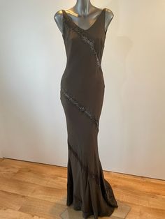 "A unique opportunity to own a beautiful Vintage Caroline Holmes Couture Gown at just 10% of it's original value from our Knightsbridge Salon.  The Gown is handmade from the finest silks, silk lined to create that extra special feeling of elegance to it's wearer. Description: Chocolate beaded bias cut gown with V neck and low V back. Made from a silk chiffon overlay on to a silk crepe backed satin. Side zipper fastening into small beaded train.   UK Size 10 Measurements: Bust 34\" Waist  25\" Hi Embellished Silk Maxi Evening Dress, Silk Sequined Maxi Dress For Wedding, Floor-length Embellished Silk Dress, Embellished Silk Floor-length Dress, Evening Gown With Beaded Straps And Floor-length, Floor-length Evening Dress With Beaded Straps, Floor-length Evening Gown With Beaded Straps, Floor-length Gown With Beaded Straps For Evening, Embellished Silk Floor-length Maxi Dress