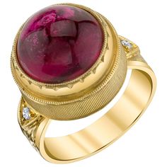 This gorgeous ring features a fine 10.75 carat rubellite tourmaline cabochon of extraordinary color and quality. A stunning gem with vibrant, rich color and excellent clarity, it is beautifully bezel set in an exquisite ring that showcases a superior level of craftsmanship seldom seen today. Two brilliant cut diamonds accent the hand-engraved band. This style is extremely comfortable to wear and perfect both for every day and special occasions! Handmade in 18k yellow gold by our Master Jewelers Rubellite Ring, Hand Engraved Rings, Diamond Signet Ring, Vintage Cocktail Ring, Rubellite Tourmaline, Pink Tourmaline Ring, Bold Rings, Gold Cocktail Ring, Gold Engraving