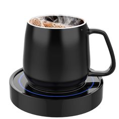 a black coffee mug on top of a stove with a blue light in the middle