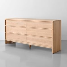 a wooden dresser sitting on top of a gray floor