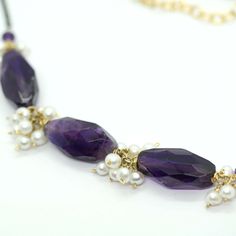 "Genuine Amethyst Gem Necklace This amethyst necklace features a Beautiful faceted Amethyst Nuggets in a deep purple color, interspaced with small clusters of Pearl beads. They are wire wrapped with gold filled wire. With oxidized silver chain and a lobster style clasp. A elegant necklaceIt, great to wear alone or layer with other chains. Amethyst is the birthstone for February and would make a great gift for someone with a birthday in that month. Amethyst is said to be a gemstone of peace, calm Purple Amethyst Gemstone Beads Pearl Necklace, Purple Amethyst Pearl Necklace With Gemstone Beads, Faceted Amethyst Healing Necklace, Purple Amethyst Pearl Necklace, Faceted Amethyst Necklaces For Jewelry Making, Purple Faceted Amethyst Crystal Necklaces, Faceted Amethyst Gemstones For Jewelry Making, Purple Faceted Amethyst Crystal Necklace, Spiritual Amethyst Necklace For Anniversary