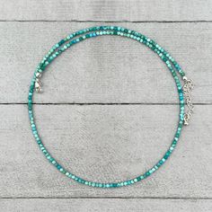 A colorful dainty turquoise necklace. These beautiful tiny (2mm) turquoise beads are faceted and have gorgeous color. The facets catch and reflect the light in beautiful ways. Finished with a lobster clasp and an extender chain and drop charm. The beads are small enough that they can fit through the bail of some pendants, for multiple ways to wear this necklace (pendants in photos are for illustrative purposes only and sold separately). The strand can also be wrapped around the wrist or ankle fo Adjustable Turquoise Beaded Amazonite Necklaces, Turquoise Faceted Beaded Bracelets, Faceted Turquoise Beaded Bracelets, Turquoise Gemstone Beads Crystal Necklace, Turquoise Single Strand Amazonite Beaded Necklace, Turquoise Amazonite Gemstone Beads Necklace, Turquoise Faceted Beads Necklace For Jewelry Making, Beaded Apatite Round Beads Jewelry, Turquoise Necklace With Faceted Beads For Jewelry Making