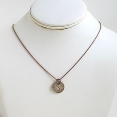 "A unique pendant necklace that I made with an original vintage San Diego transit token (this token was first used in 1953). The coin is solid bronze and 5/8\" in diameter (I especially like the cut-out \"S\" in the center). The chain is antiqued bronze tone with a large lobster claw clasp and you can choose 18\" or 20\" length. It will come in a new gift box and the one in the photos is the exact piece you will receive. If you need more than one, please let me know. I also have a wide variety o Bronze Brass Coin Necklace With Round Pendant, Vintage Brass Charm Necklace With Coin Pendant, Anniversary Medallion Necklace With Antique Finish, Antique Finish Medallion Necklace For Anniversary, Vintage Brass Coin Necklace With Round Pendant, Vintage Bronze Necklace With Coin Pendant, Vintage Adjustable Coin Necklace, Vintage Bronze Necklaces With Coin Pendant, Vintage Brass Coin Necklace Nickel Free