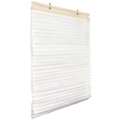 a white window blind hanging on the side of a wall