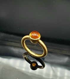 If you like the minimalistic look this ring is for you. This Vintage (1990s) 14k gold ring has those simple and strong lines that are timeless. The beautiful golden colored cabochon citrine measures 7mm in diameter. The patina is 18k matte finish. It has a very solid feel and it weighs 5.9 grams. Its currently a size 7 but is resizeable by any competent jeweler if needed. Modern Gold Signet Ring With Cabochon, Modern Yellow Gold Signet Ring With Cabochon, Modern Yellow Gold Cabochon Rings, Modern Gold Oval Cabochon Dome Ring, Modern Yellow Gold Dome Ring With Cabochon, Modern Gold Dome Ring With Oval Cabochon, Modern Citrine Ring In Yellow Gold, Modern Yellow Gold Citrine Ring, Modern Gold Moonstone Ring For Formal Occasions